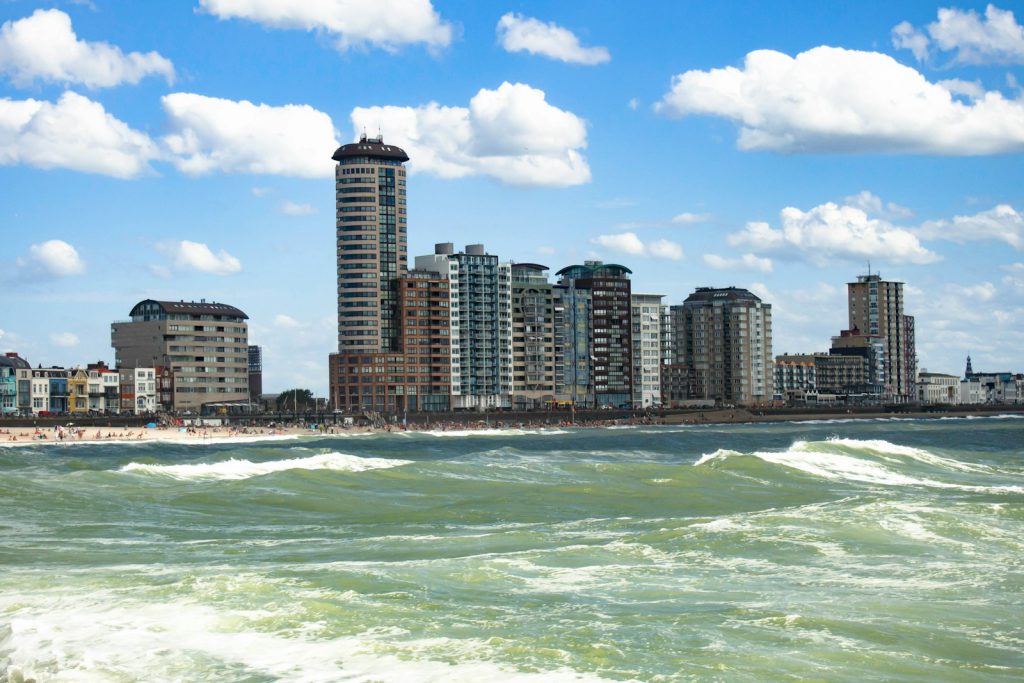 high rise buildings near sea under blue sky  leuke kinder uitjes zeeland vlissingen during daytime